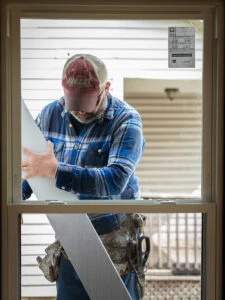 man fixing window frame